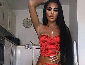 findom babe in shiny red corset and stockings